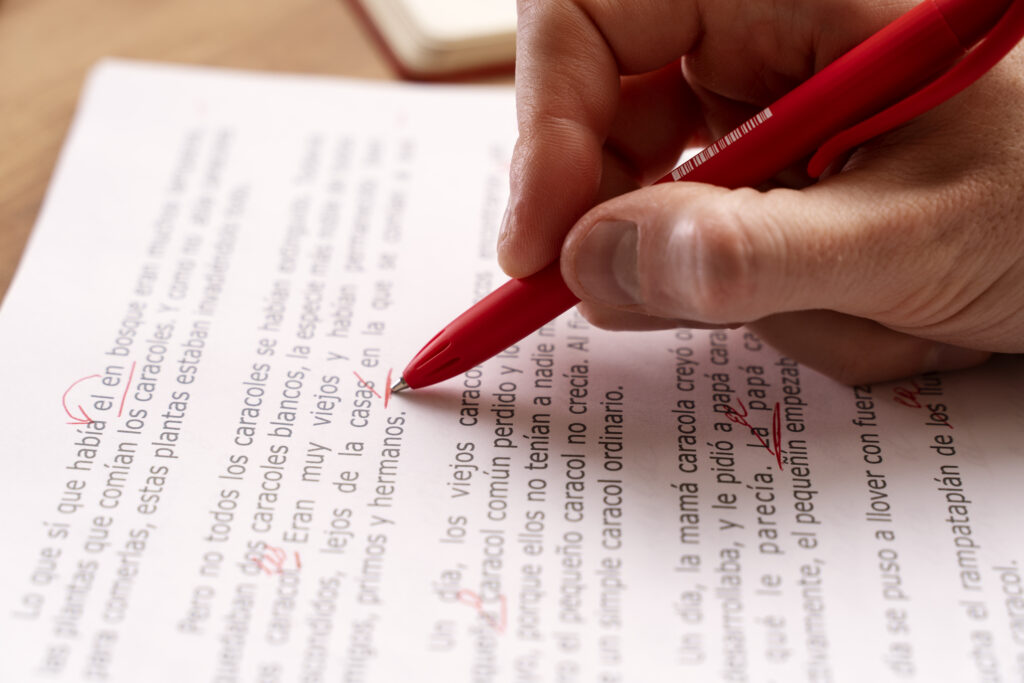 high-angle-hand-correcting-grammar-mistakes