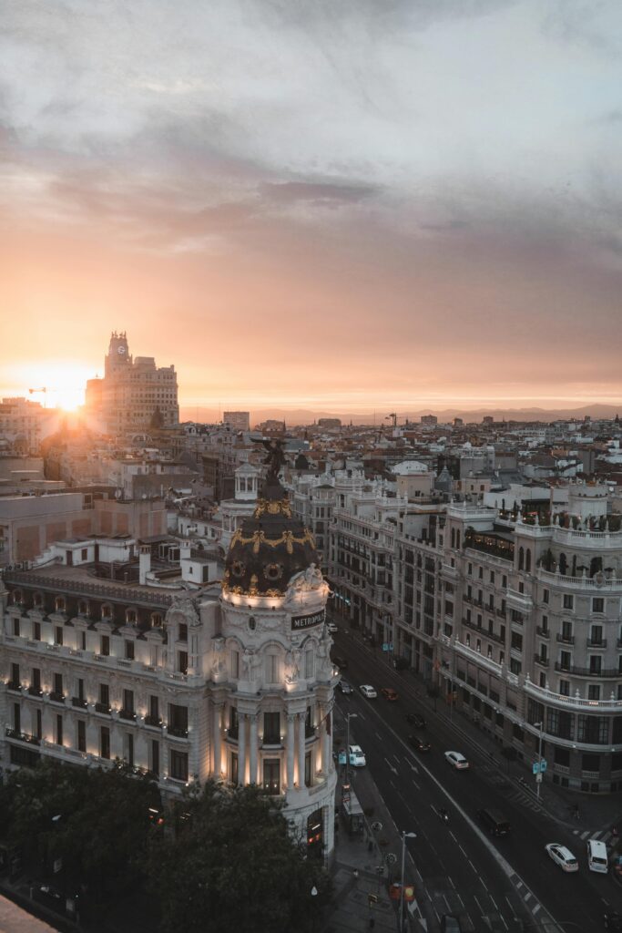 Stunning view of Madrid cityscape with sunset over the Metropolis Building.